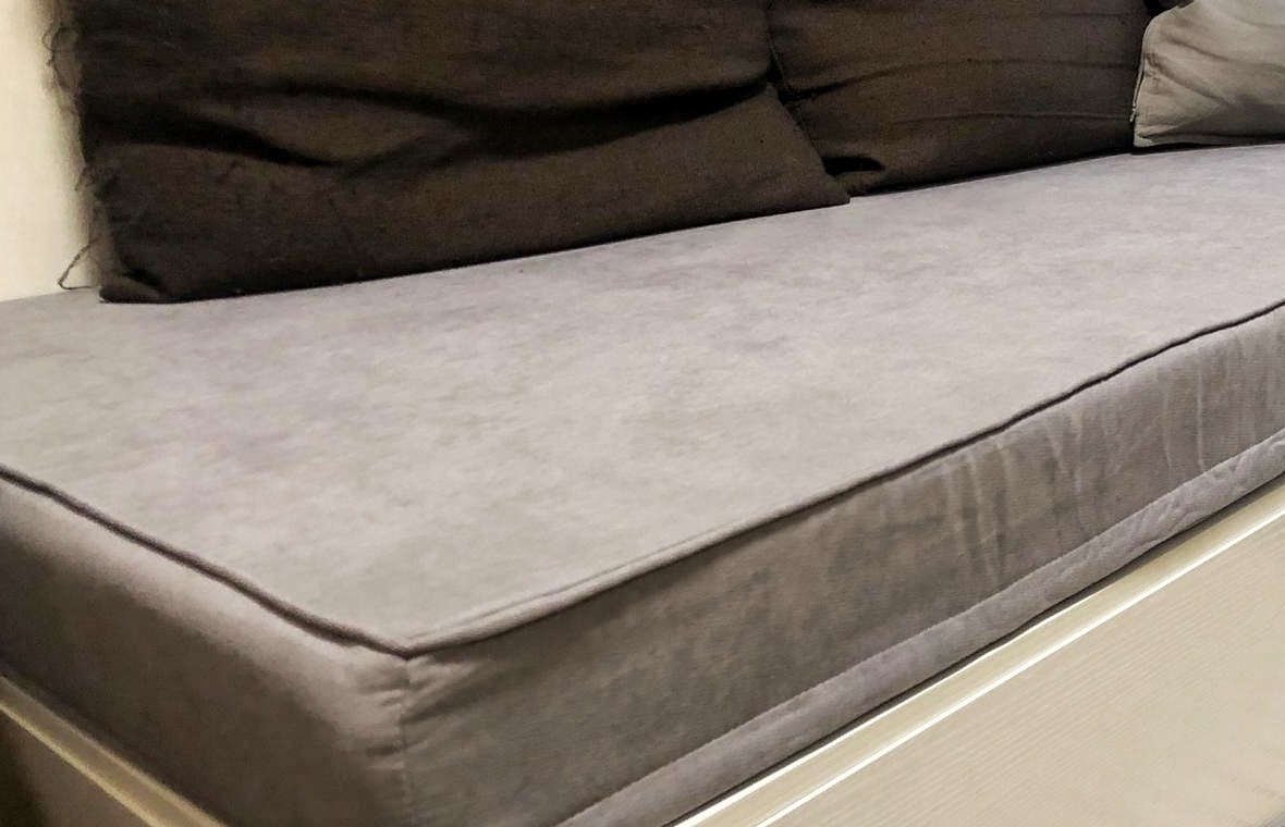Grey custom cushion on a white window sill bench