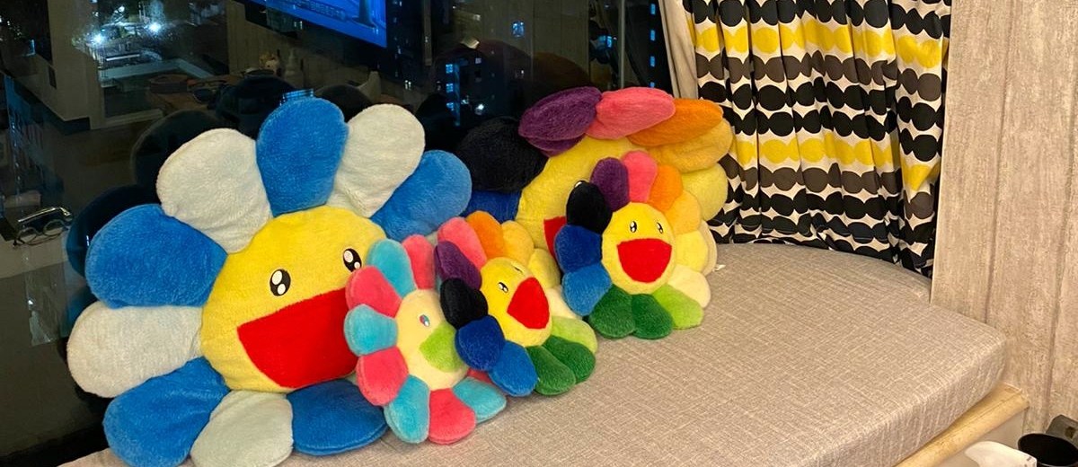 Grey custom baywindow cushion with colourful pillows at night